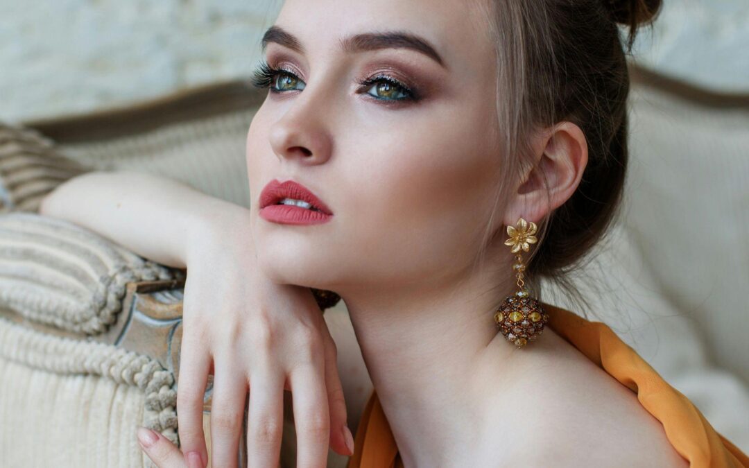 A close-up of a woman with full make-up and waxed upper lip